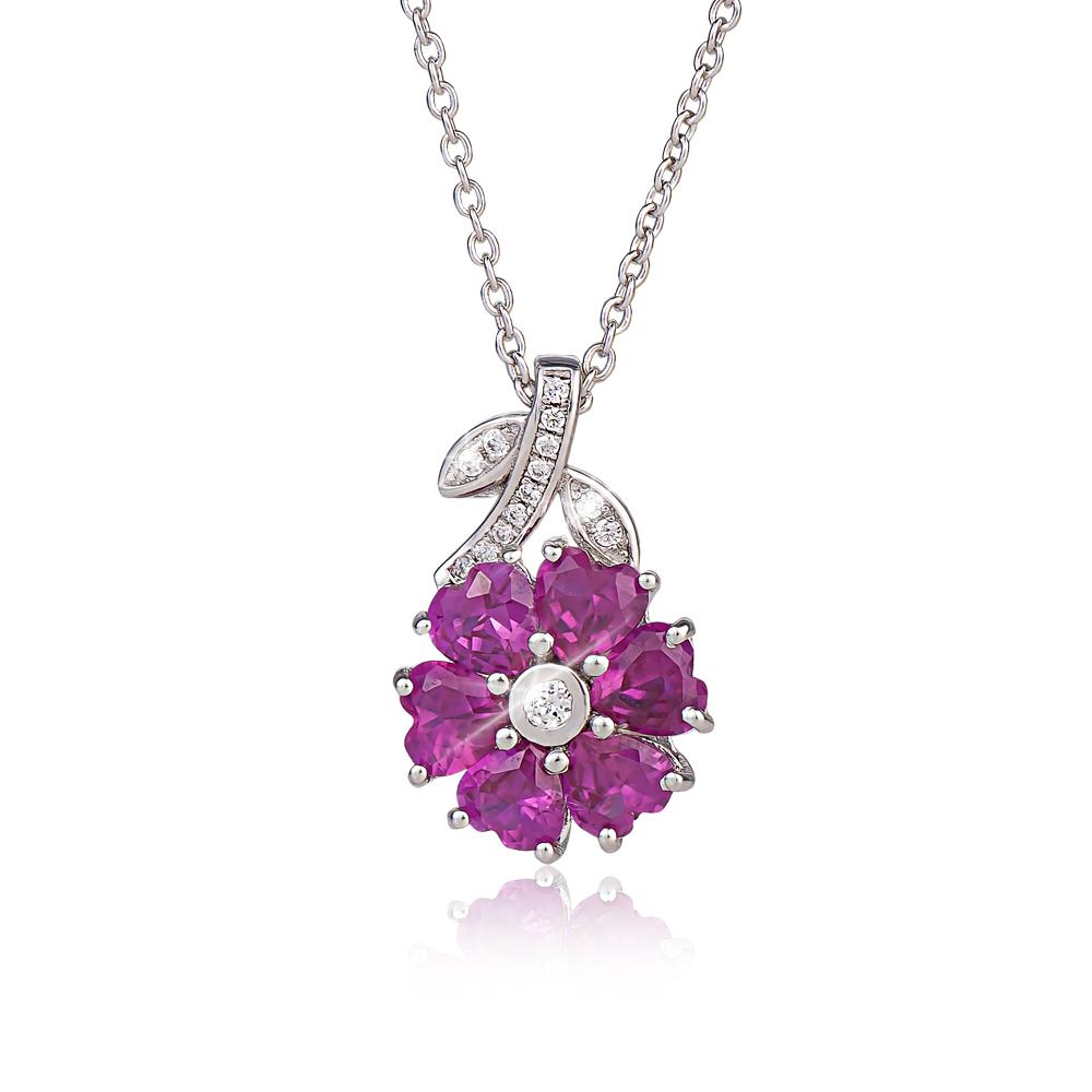 Charlotte Pendant featuring a sterling silver and rhodium-plated floral design with vibrant purple gemstones and sparkling clear accents, elegant jewelry for women.