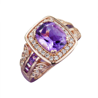 Amethyst Rose Ring featuring a sterling silver band plated in rose gold, adorned with a large purple amethyst center stone and surrounded by sparkling clear gemstones, designed for women.
