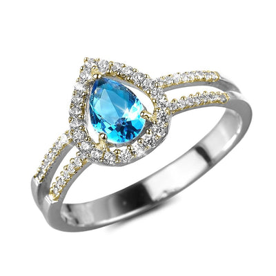 Dewdrop Halo Ring featuring a sterling silver band with a pear-shaped blue gemstone surrounded by a halo of sparkling accents, designed for women’s jewelry.