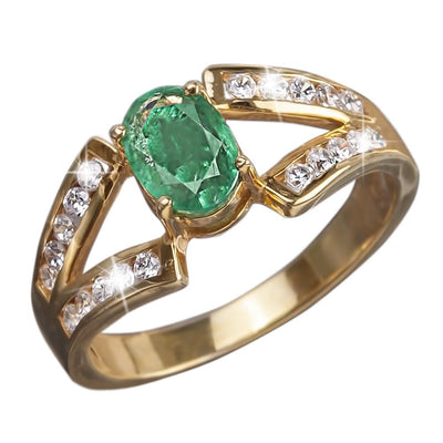 Emerald Orchard Ring featuring a gold-plated sterling silver band adorned with sparkling clear stones and a vibrant green central emerald gemstone, designed for women’s jewelry.