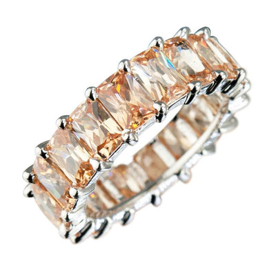 Champagne Forever Baguette Eternity Ring featuring rectangular champagne stones set in rhodium-plated sterling silver, designed for women’s jewelry collections.