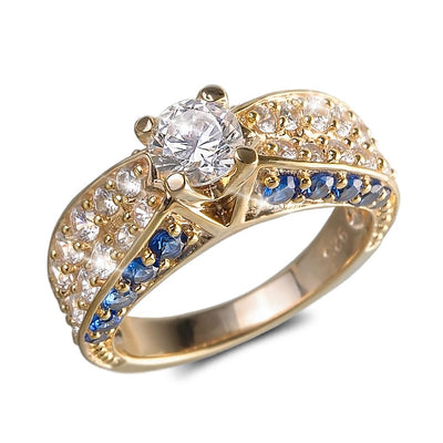 Arianna Ocean Ring in sterling silver with gold plating, featuring a central round clear gemstone surrounded by smaller clear crystals and blue stones in an elegant design for females.