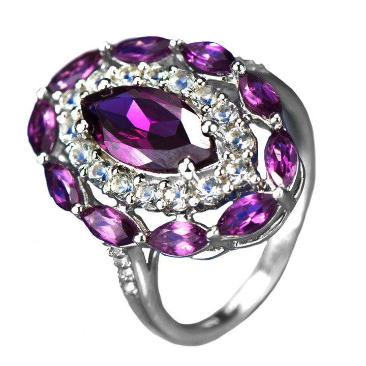 Rhodolite Rhapsody Ring featuring a sterling silver band plated with rhodium, adorned with vibrant purple rhodolite gemstones and sparkling clear accents, designed for women.