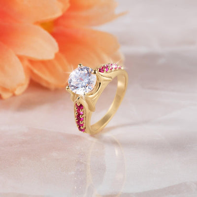 Salamanca Ring featuring a sterling silver base with gold plating, adorned with a large clear gemstone and small red stones, designed for women’s jewelry.