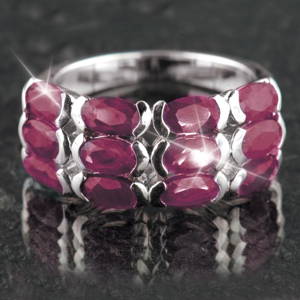 Ruby Band Ring featuring multiple oval-shaped red ruby gemstones set in sterling silver with rhodium plating, designed for women’s elegant jewelry collections.