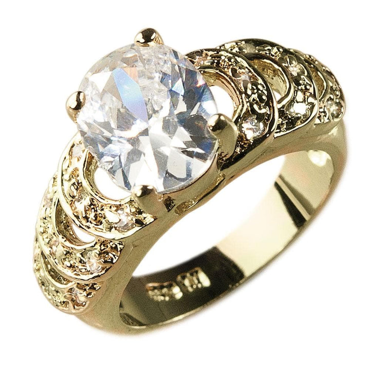 Palm Bay Ring featuring a large oval clear gemstone set in gold-plated sterling silver with intricate textured detailing, designed for women’s jewelry collection.