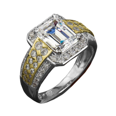 Fineza Ring featuring an emerald-cut clear gemstone set in sterling silver with two-tone plating, accented by smaller sparkling stones, designed for women’s jewelry.