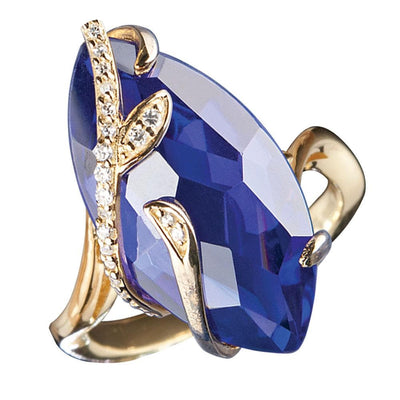 Tanzania Vine Ring featuring a large marquise-cut deep blue gemstone set in sterling silver with gold plating and delicate vine-inspired accents adorned with small clear crystals, designed for women.