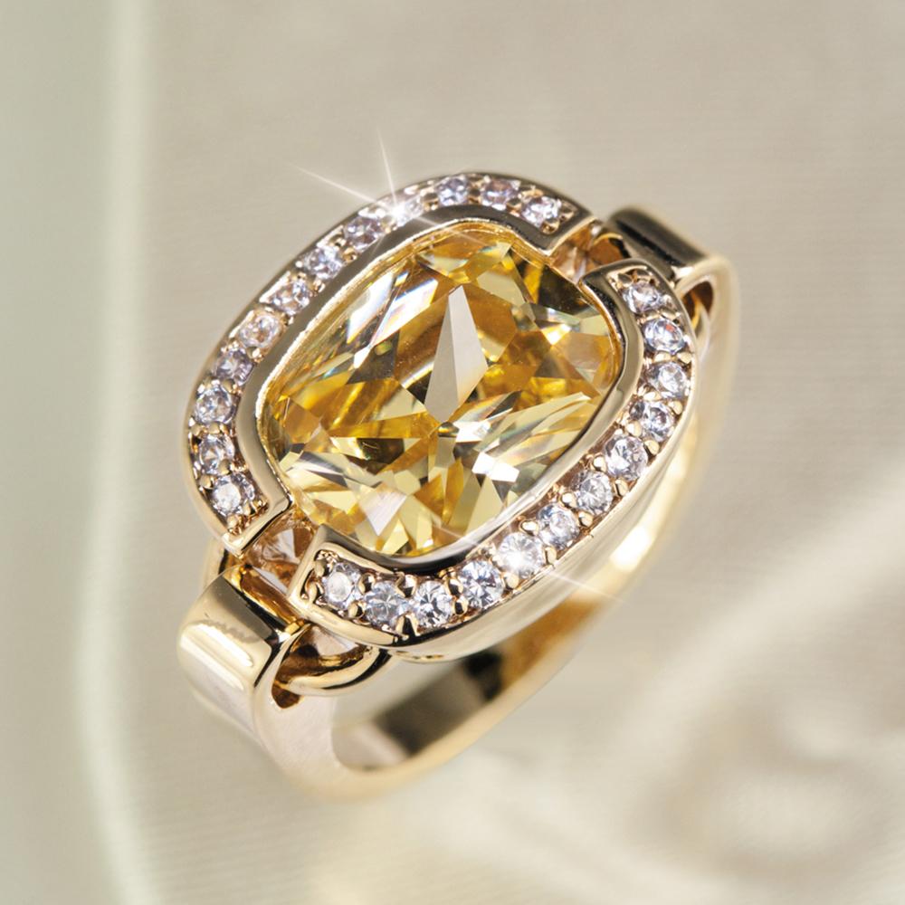 Valenciana Ring featuring a large yellow gemstone centerpiece surrounded by smaller clear stones, crafted in sterling silver with gold plating for women’s elegant jewelry.